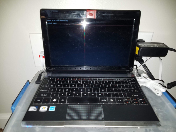 Picture of old netbook displaying a Linux login prompt
